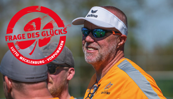 Markus Grahn, Head-Coach der Rostock Griffins mit Sonnenbrille und Cap zur seite blickend auf dem Spielfeld